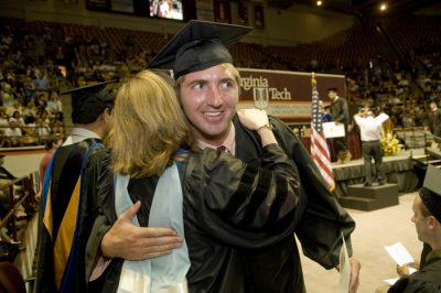 Happy graduates congratulate each other at the Pamplin College of Business ceremony