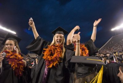 Happy graduates cheer during the University Commencement Ceremony